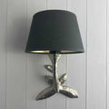 Laurier Wall Light with bronze leaf design and black fabric shade mounted on white paneled wall