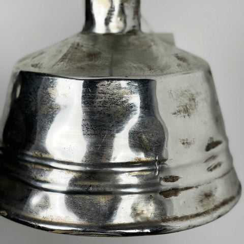 Close-up of a hammered textured nickel bell pendant light with a brushed silver finish