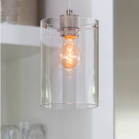 Dunsford cylindrical pendant light with clear glass shade and exposed filament bulb in modern interior setting