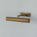 Cambridge Adjustable Brass Picture Light in reeded antique brass finish illuminating framed artwork on wall