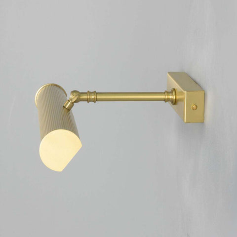 Cambridge Adjustable Brass Picture Light in reeded brass with cylindrical shade for gallery and artwork lighting