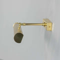 Cambridge Adjustable Brass Picture Light in antique brass illuminating framed artwork