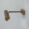 Cambridge Adjustable Brass Picture Light in reeded brass finish illuminating framed artwork on wall