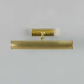 Cambridge Adjustable Brass Picture Light in reeded solid brass with adjustable arm and warm finish illuminating artwork