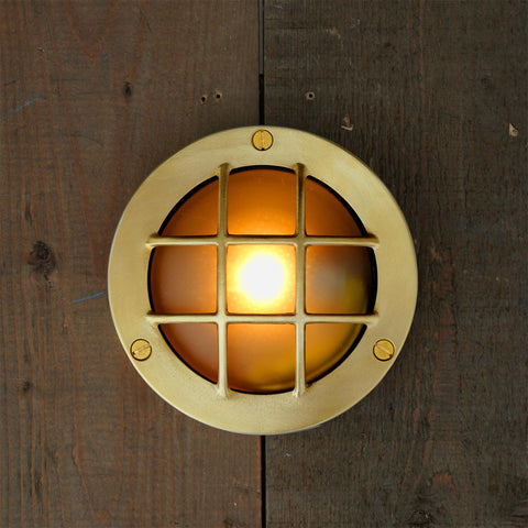 Muara Bulkhead IP64 outdoor wall light with circular design and protective grille for durable exterior lighting