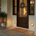 Muara Bulkhead IP64 outdoor wall light with protective grille and industrial design, ideal for patios and garden walls