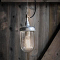 St Ives Harbour Outdoor Pendant Light with galvanized steel finish and vintage filament bulb against wooden background