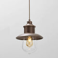 Guinguette outdoor aged brass pendant light with clear glass shade and exposed bulb hanging from a fixed rod