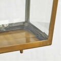 Close-up of Pooky Crail Lantern outdoor ceiling light with brass frame and beveled glass panels