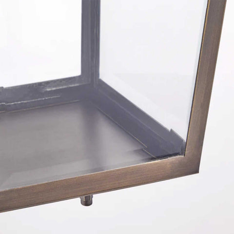 Close-up of Pooky Crail Lantern outdoor ceiling light with brass frame and bevelled glass panels