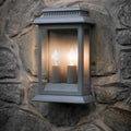 Belvedere Outdoor charcoal grey wall light with dual bulbs mounted on stone wall for exterior lighting