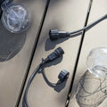 Festoon Classic Lights extension kit with connectors and clear bulbs on wooden surface for outdoor string lighting expansion