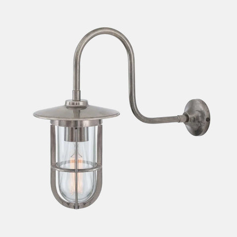 Denham Outdoor Swan Neck Wall Light in antique silver finish with brass cage and glass shade for durable outdoor lighting