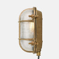 Ruben Small Outdoor Wall Light with weatherproof brass finish and ribbed glass, designed for indoor and outdoor use with nautical industrial style.