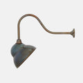 Fairburn IP23 Wall Light with a curved metal arm and retro cap-style brass shade for outdoor use