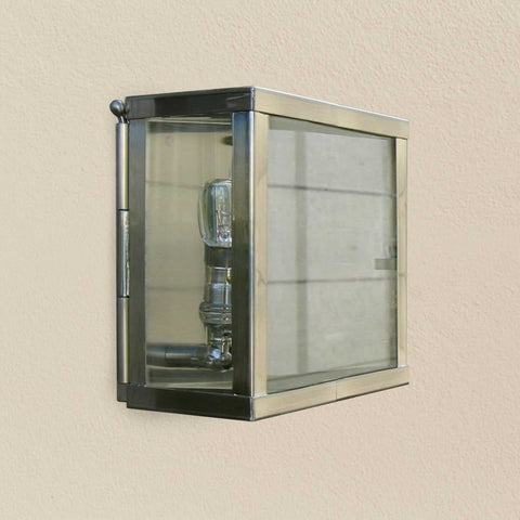 Chiswick Outdoor Double Lamp wall light with polished metal frame and clear glass panels mounted on beige wall