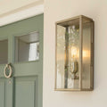 Chiswick Outdoor Wall Light large modern glass and metal outdoor light fixture mounted beside a green front door