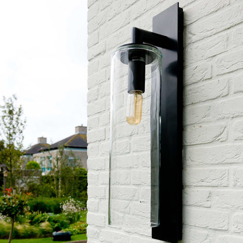 Contemporary Dome Outdoor Wall Light with black powder-coated metal and mouth-blown glass mounted on white brick wall