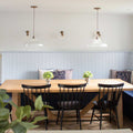 Mono Prismatic Pendant Light with prismatic glass shades hanging above a wooden dining table in a modern dining room