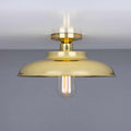 Telal Flush Ceiling Light with a brass finish and exposed vintage bulb, minimalist industrial style ceiling fixture