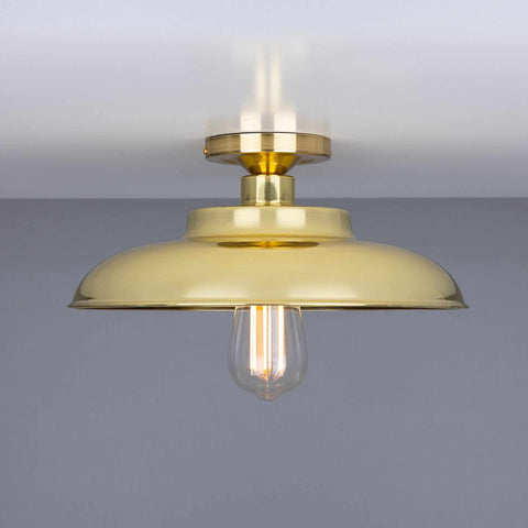 Telal Flush Ceiling Light with a brass finish and exposed vintage bulb, minimalist industrial style ceiling fixture