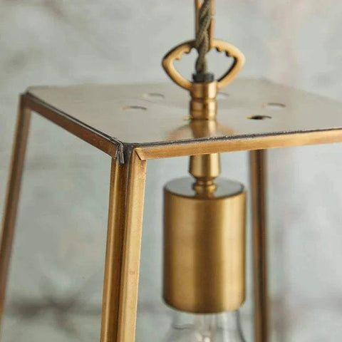 Medium Luxor Lantern Pendant light with clear glass panels and antiqued brass frame in close-up detail