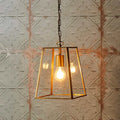Medium Luxor Lantern Pendant light with clear glass panels and antiqued brass frame illuminating warm light