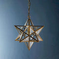 Pooky Stella Star Pendant Light medium clear glass star-shaped ceiling light with brass frame and chain suspension