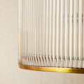 Close-up of Artemis Chandelier pendant light showing brass frame and clear glass rods detail.