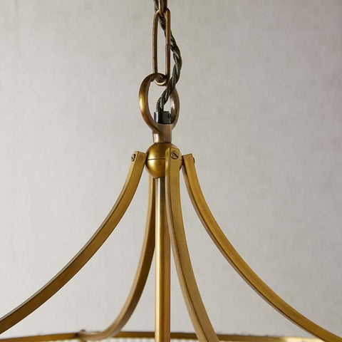 Close-up of the Pooky Artemis Chandelier pendant light showing its elegant brass rod structure and hanging chain.