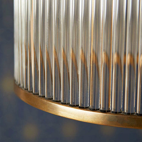 Close-up of Pooky Valli Pendant Light showing glass rods and brass finish with warm ambient glow