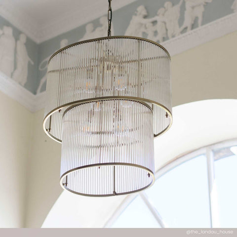 Loki Two-Tiered Oval Chandelier pendant light with brass frame and glass rods providing elegant ambient lighting for modern interiors