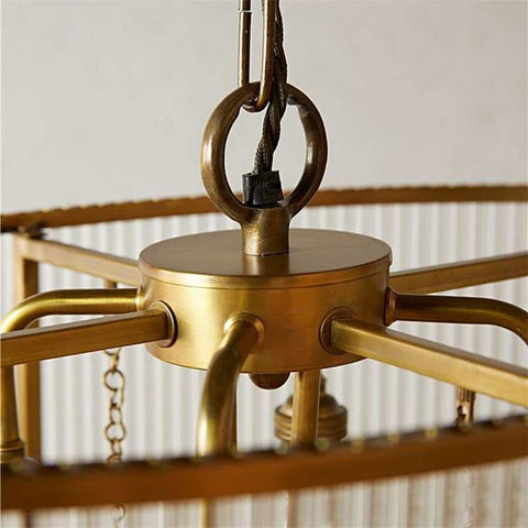 Close-up of brass oval frame and suspension detail of the Loki Two-Tiered Oval Chandelier with glass rods