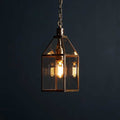 Pooky Carrington Lantern pendant light in antique brass with vintage glass lantern and glowing filament bulb
