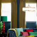 Pooky Athena Chandelier pendant light with brass frame and glass rods in stylish living room setting