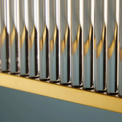 Close-up detail of the Odin Chandelier showcasing handcrafted glass rods and a golden brass frame.