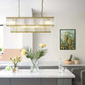Odin Chandelier pendant light with handcrafted glass rods and brass frame above modern kitchen island