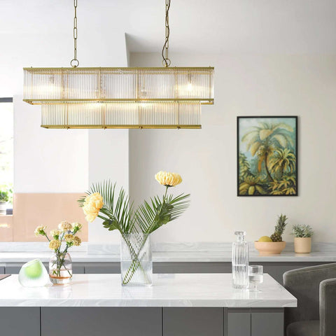 Odin Chandelier pendant light with handcrafted glass rods and brass frame above modern kitchen island