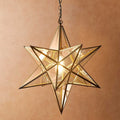 Pooky Stella Star Pendant giant clear glass star-shaped ceiling light with brass finish illuminating warmly