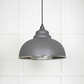 Brampton Grey Pendant Light with domed grey steel shade and polished nickel interior hanging against white paneled wall