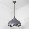 Brampton Grey Pendant Light with domed grey steel exterior and polished nickel hammered interior hanging in minimalist white room
