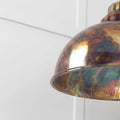 Brampton burnished pendant light with hand-burnished brass finish and hammered interior providing warm, textured glow.