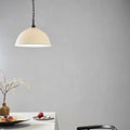 Denton large ribbed ceramic shade pendant light hanging over a dining table with minimal decor and neutral gray wall background