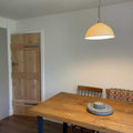 Denton large ribbed ceramic shade pendant light hanging above wooden dining table in modern room