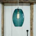 Camber large teal glass shade pendant light with vintage bulb and adjustable hanging cord in modern interior setting