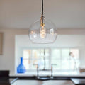 Soho Medium Clear Glass Shade pendant light with exposed filament bulb in modern kitchen setting