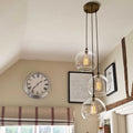 Soho large clear glass shade cluster pendant light with three hand-blown glass globes in modern living room setting