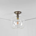 Soho medium clear glass globe flush ceiling light with exposed filament bulb and metal mount