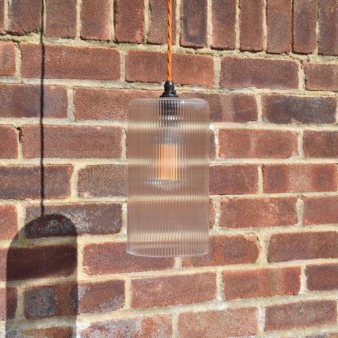 Brook Large Ribbed Glass Shade pendant light with adjustable flex, vintage handblown ribbed glass shade against brick wall background