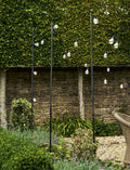 Steel festoon poles with bull horn design for outdoor lighting in garden setting